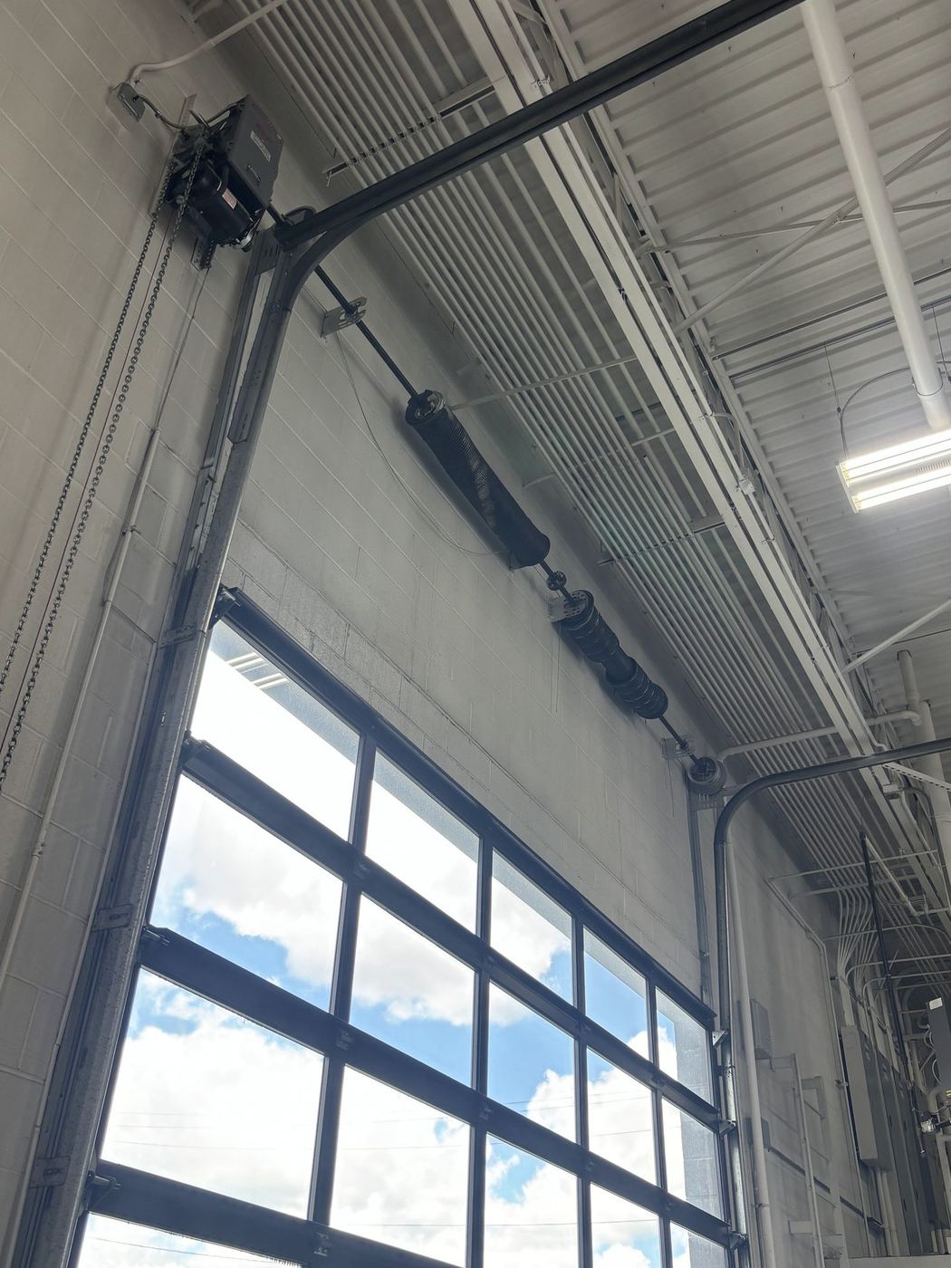 Full-view glass door with vertical-lift track