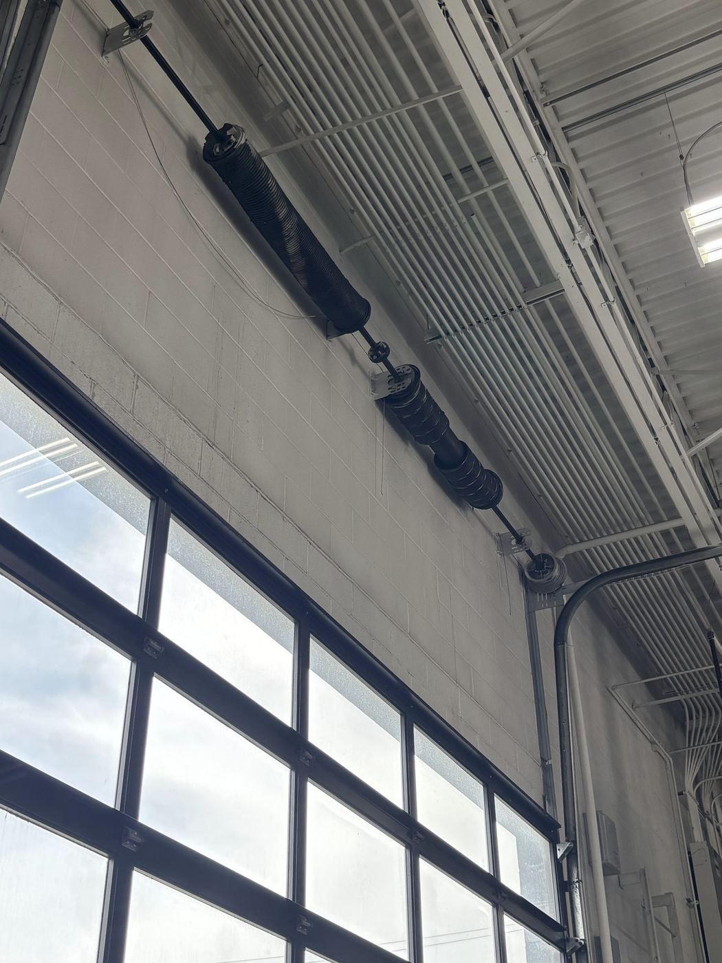 Torsion spring on a full-view door