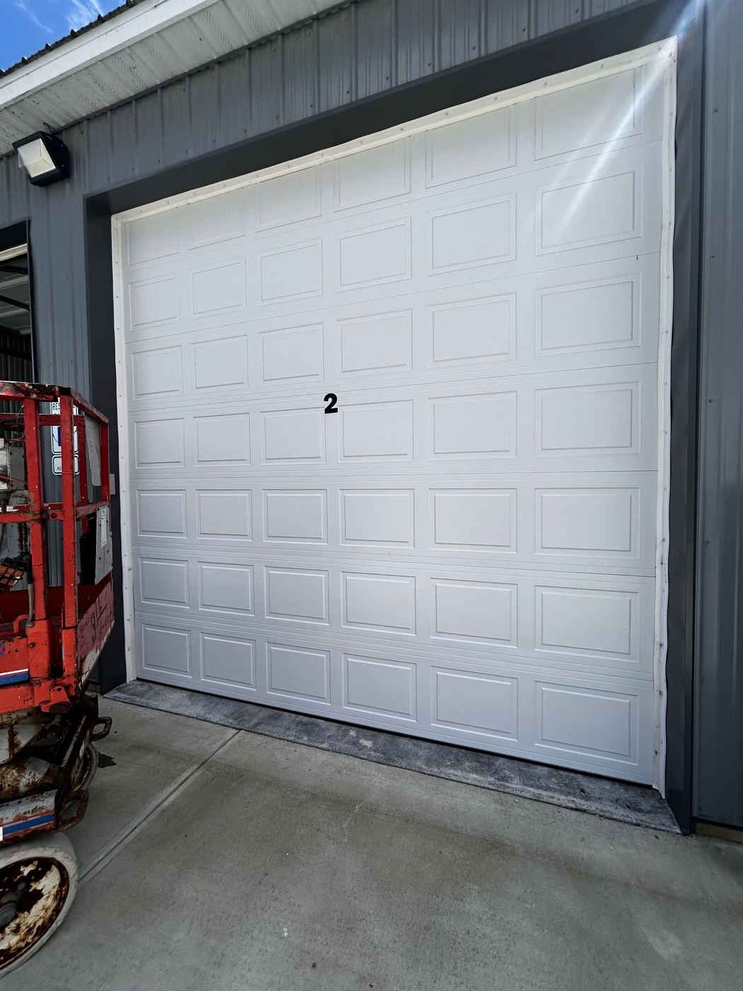 Sectional door install from a scissor lift